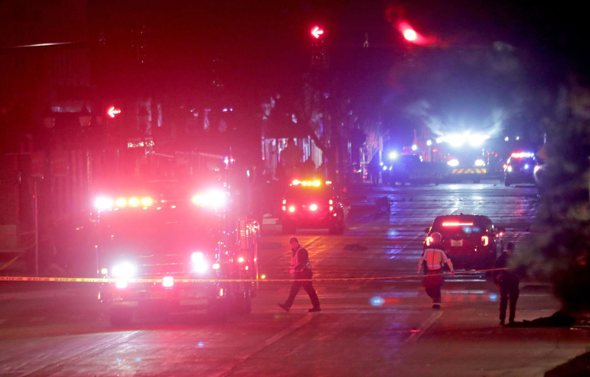 <i>Mike De Sisti/Milwaukee Journal-Sentinel/AP</i><br/>Police investigate at the scene of a crash involving multiple people and injuries at a holiday parade in Waukesha