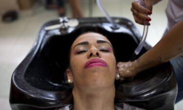 An inmate has her hair washed as she prepares to compete in the 13th annual Miss Talavera Bruce beauty pageant at the penitentiary the pageant is named for