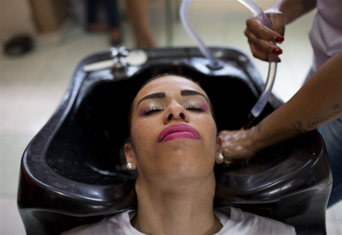 <i>Silvia Izquierdo/AP</i><br/>An inmate has her hair washed as she prepares to compete in the 13th annual Miss Talavera Bruce beauty pageant at the penitentiary the pageant is named for