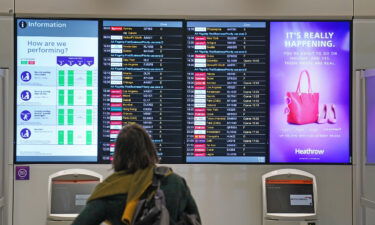 A passenger looks at a departures board at London Heathrow Airport's T3 as the US reopens its borders to UK visitors in a significant boost to the travel sector. Thousands of travellers are jetting off on transatlantic flights for long-awaited reunions with family and friends.