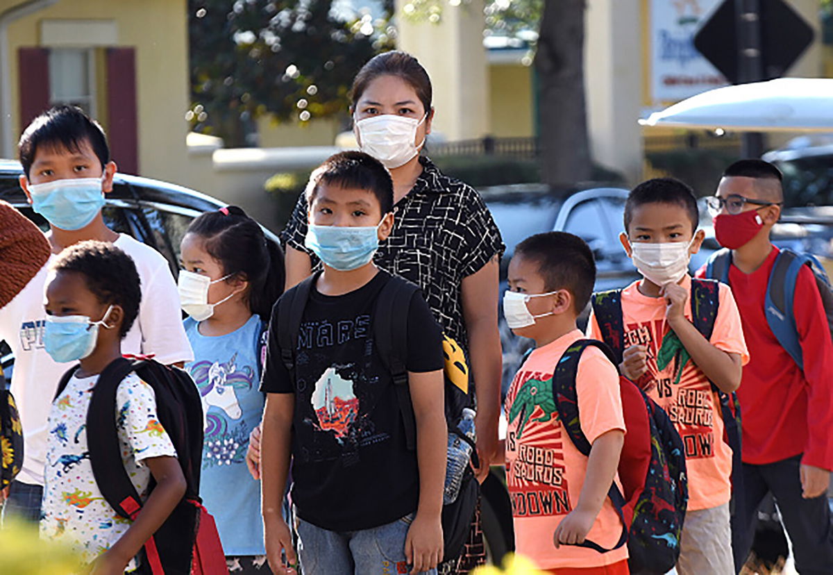 <i>SOPA Images/SOPA Images/LightRocket via Getty</i><br/>Students are shown here wearing face masks arrive on the first day of classes for the 2021-22 school year at Baldwin Park Elementary School.