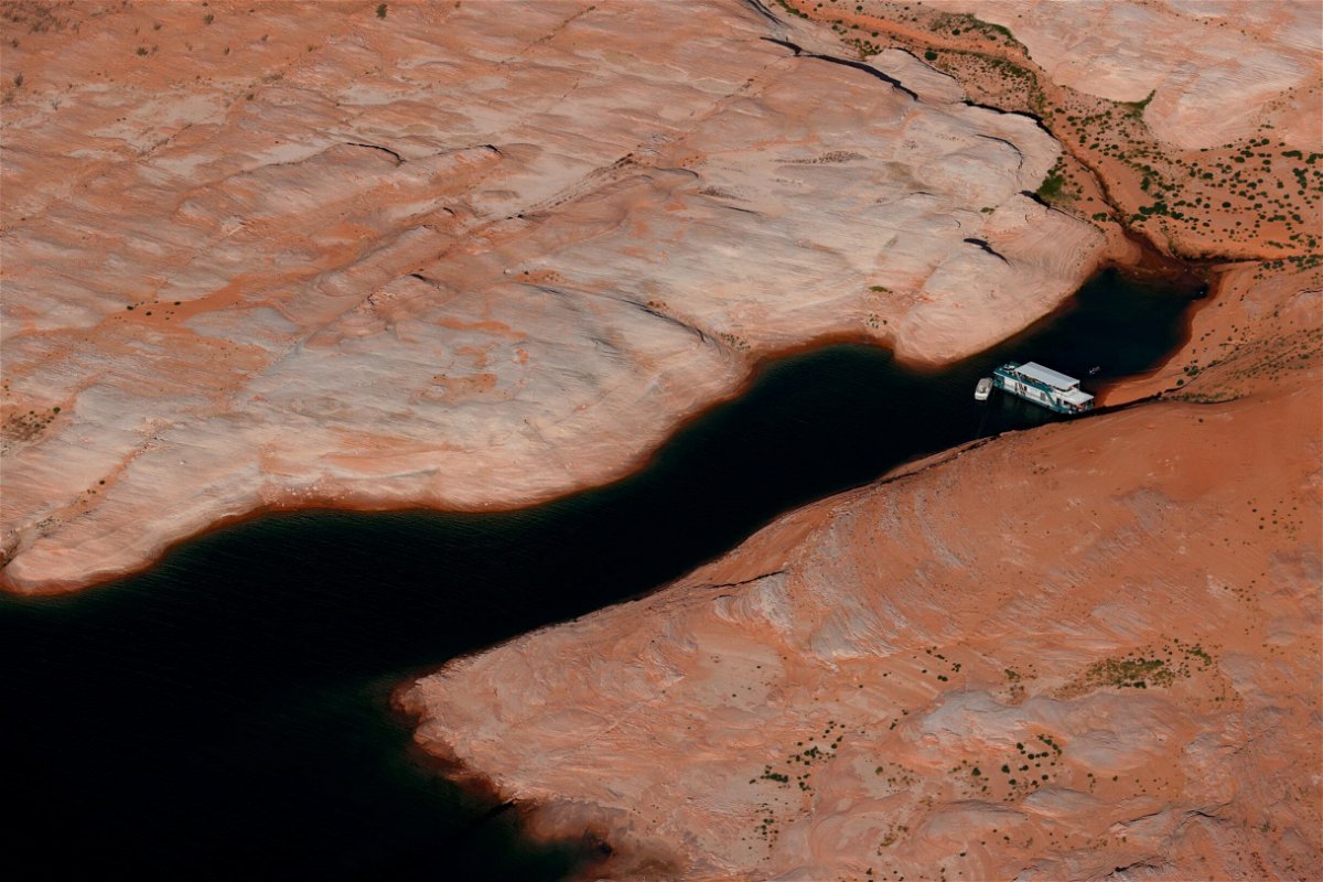 <i>Justin Sullivan/Getty Images</i><br/>A house boat sits docked in a section of Lake Powell
