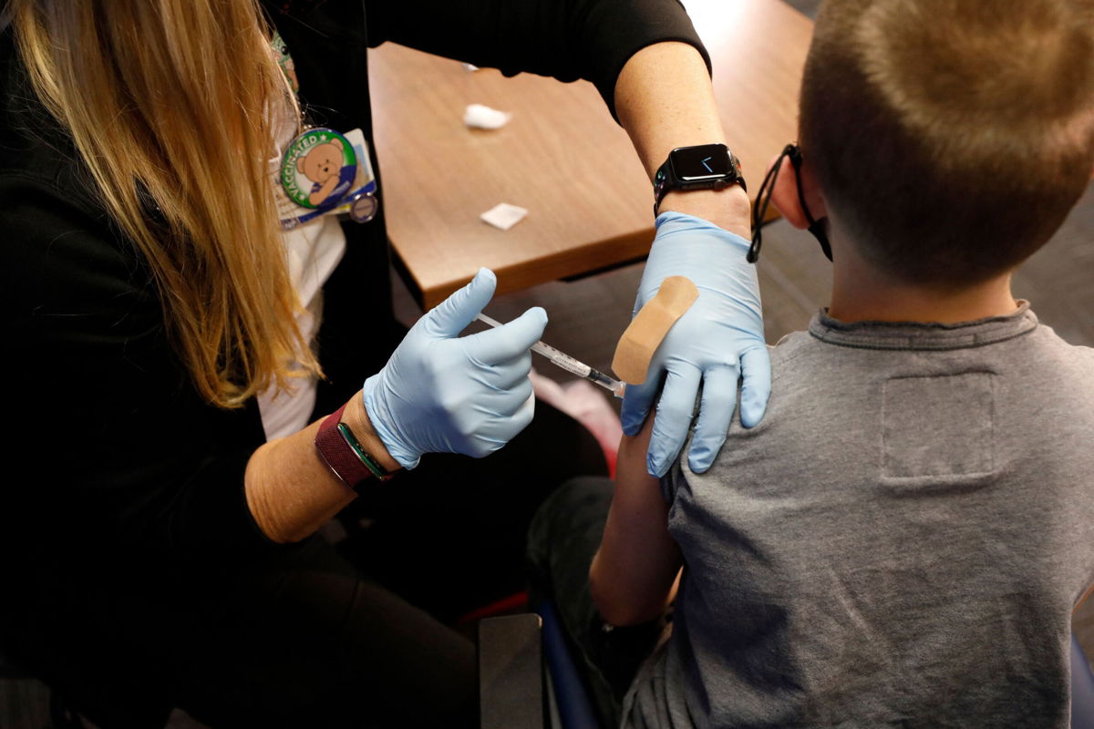 <i>Jeff Kowalsky/AFP/Getty Images</i><br/>Kids receiving their first dose of the Covid-19 vaccine now will be partially protected by Thanksgiving. An 8-year-old receives the Pfizer-BioNTech vaccine in Southfield