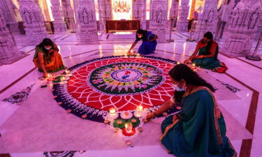 How Indian Americans are making Diwali their own. Women are seen tending to a rangoli during a Diwali celebration in Chino Hills