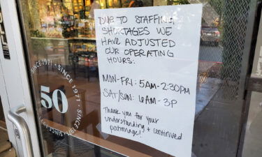A handwritten sign explains reduced hours at a Starbucks Cofee cafe in Lafayette