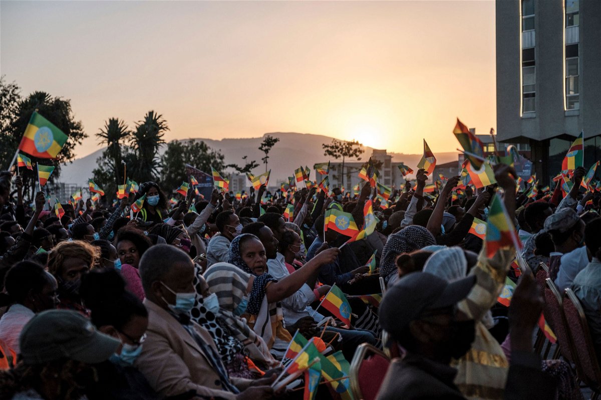 <i>Eduardo Soteras/AFP/Getty Images</i><br/>A crowd wave Ethiopian flags during a memorial service for the victims of the Tigray conflict organized by the city administration