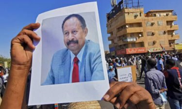 A Sudanese anti-coup protester carries a portrait of ousted Prime Minister Abdalla Hamdok at a demonstration in Khartoum on November 13.