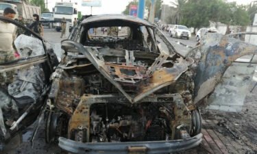 The wreckage of a car at the site of an explosion that killed a journalist in Aden