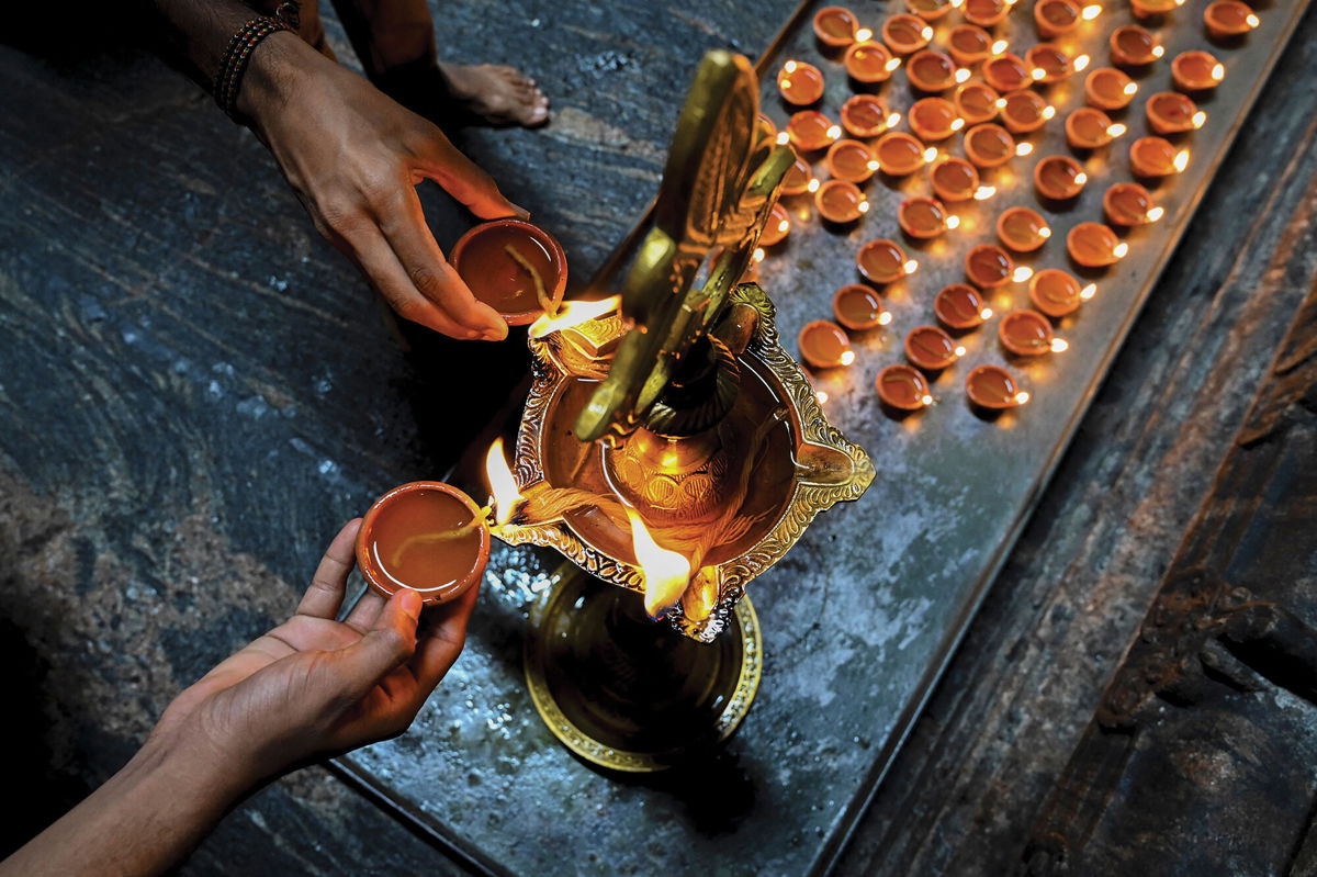 <i>Ishara S. Kodikara/AFP/Getty Images</i><br/>Google is commemorating Diwali with a special Easter egg. Hindu devotees are seen lighting oil lamps while offering prayers during Diwali on November 4.