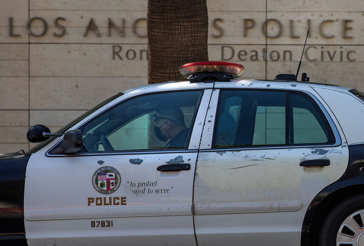 <i>Mel Melcon/Los Angeles Times/Getty Images/File</i><br/>A member of the LAPD sits inside his squad car