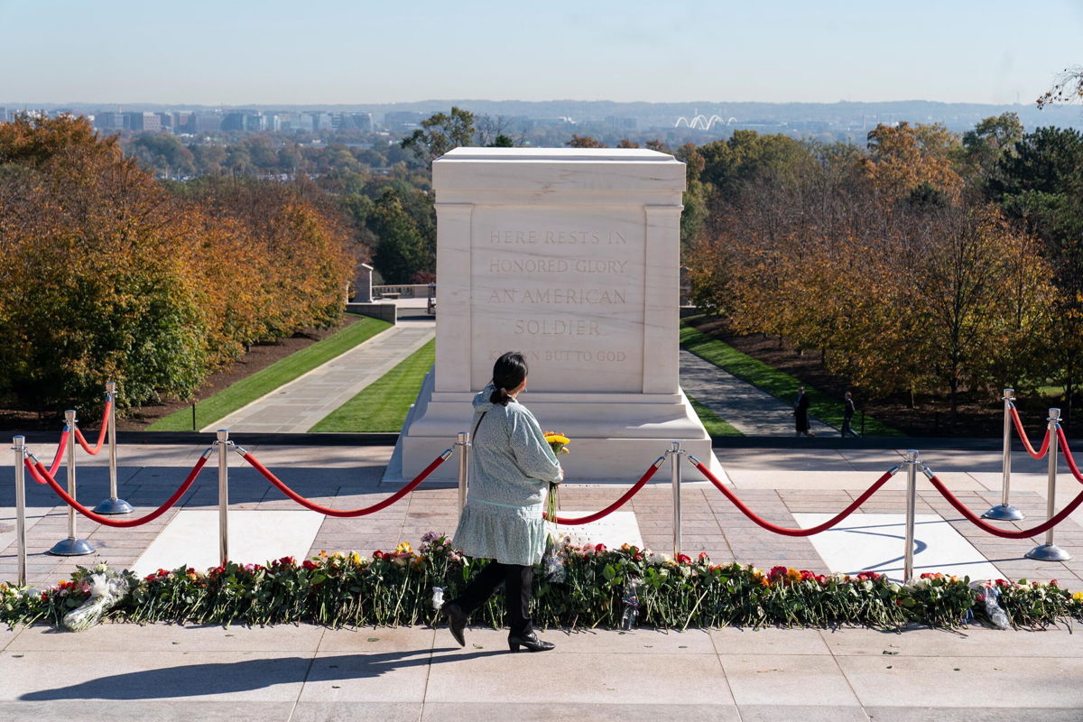 <i>Alex Brandon/AP</i><br/>A woman arrives to place flowers during a centennial commemoration event at the Tomb of the Unknown Soldier