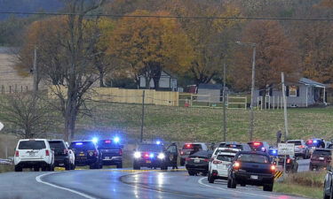 Authorities work at the scene where four people were found dead in a vehicle -- in what police say was a murder-suicide incident -- on Thursday outside Ringgold