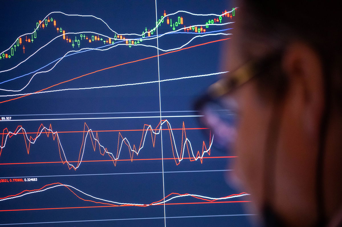 <i>Michael Nagle/Bloomberg/Getty Images</i><br/>The market may be ignoring risks and signs of froth and excess. A trader is shown working on the floor of the New York Stock Exchange (NYSE) in New York