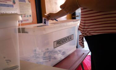 A voter casts her ballot during national elections on November 21 in Arica