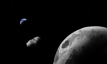 An artist's impression of quasi-satellite Kamo`oalewa near Earth and the moon is shown.