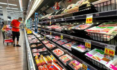 A person shops in the meat section of a grocery store on November 11 in Los Angeles