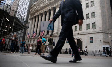 Wall Street bankers are expected to get big increases in their bonus checks this year. Pedestrians pass in front of the New York Stock Exchange (NYSE) in New York