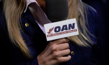 A reporter with One America News Network works at a campaign rally with President Donald Trump at Newport News/Williamsburg International Airport in September of 2020 in Newport News