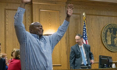 Dontae Sharpe enters a Pitt County courtroom to the cheers of his family after a judge determined he could be set free on a $100