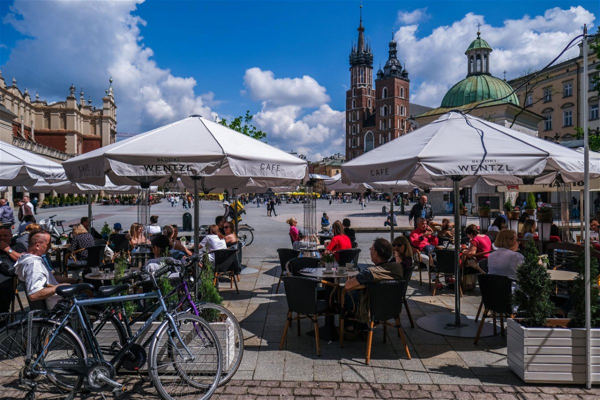 <i>Omar Marques/Getty Images</i><br/>People enjoy drinks and food on an outdoor garden bar at Krakow's UNESCO listed Main Square on May 15 in Krakow