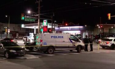 Police say two men are being questioned after a 14-year-old boy was shot and killed while waiting on a bus.