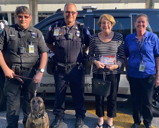<i>Pensacola Police Department/Facebook</i><br/>Mrs. Ann (center right) purchased five planes tickets for the family that was stranded on the highway.