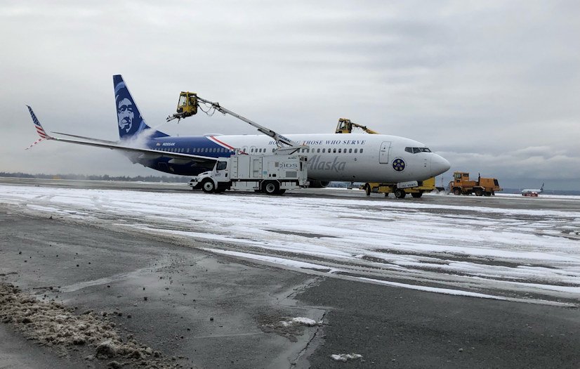 Crews de-ice Alaska Airlines flight at Sea-Tac Airport.