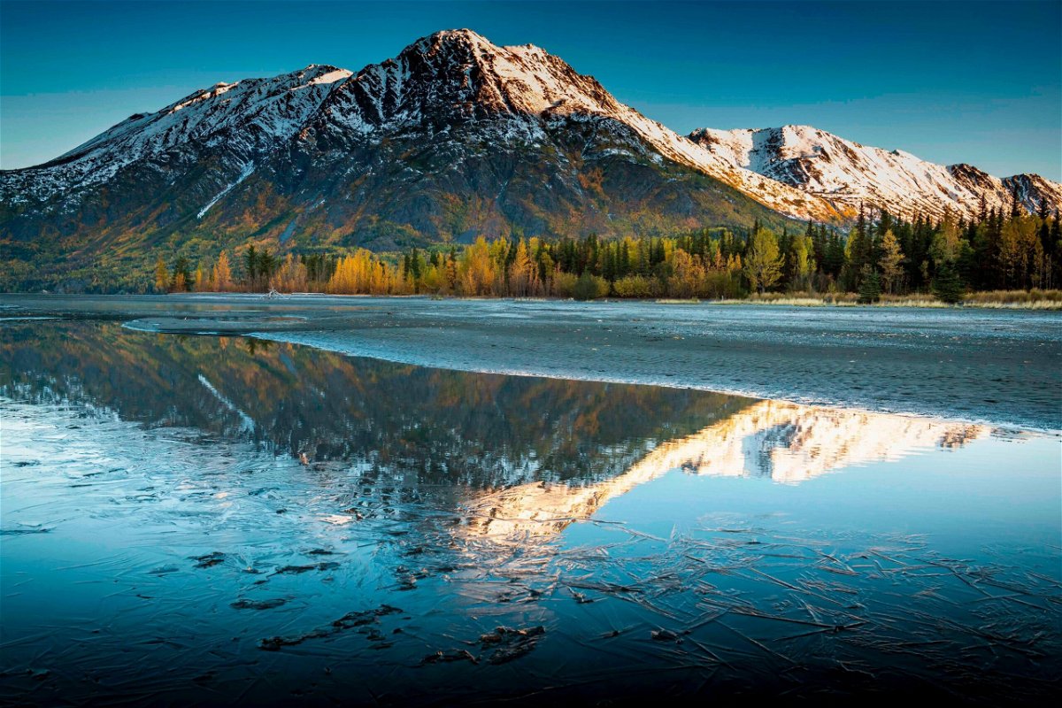 <i>Christopher Miller/The New York Times/Redux</i><br/>A frozen Kenai Lake reflects Langille Mountain in Alaska in September. With a high of 67 degrees