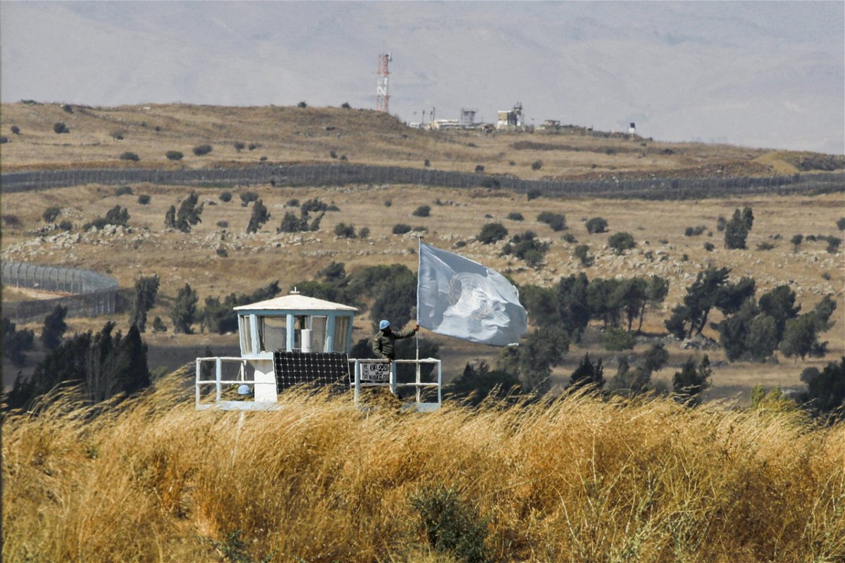 <i>JALAA MAREY/AFP/AFP via Getty Images</i><br/>A UN peacekeeper stands on duty at an outpost of the United Nations Disengagement Observer Force (UNDOF) buffer zone between Syria and the Israeli-annexed Golan Heights on August 11