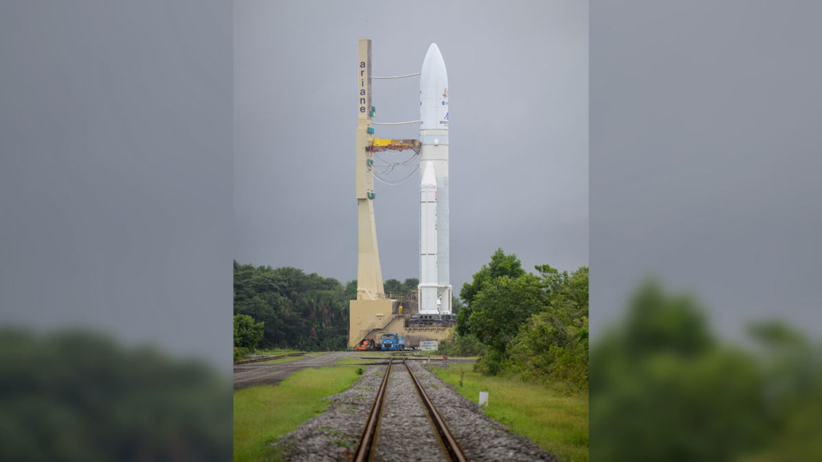 <i>Bill Ingalls/NASA</i><br/>The Ariane 5 rocket and its cargo towers above the surroundings in French Guiana.