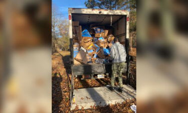 Packages thrown into an Alabama ravine are loaded onto a truck on November 25.