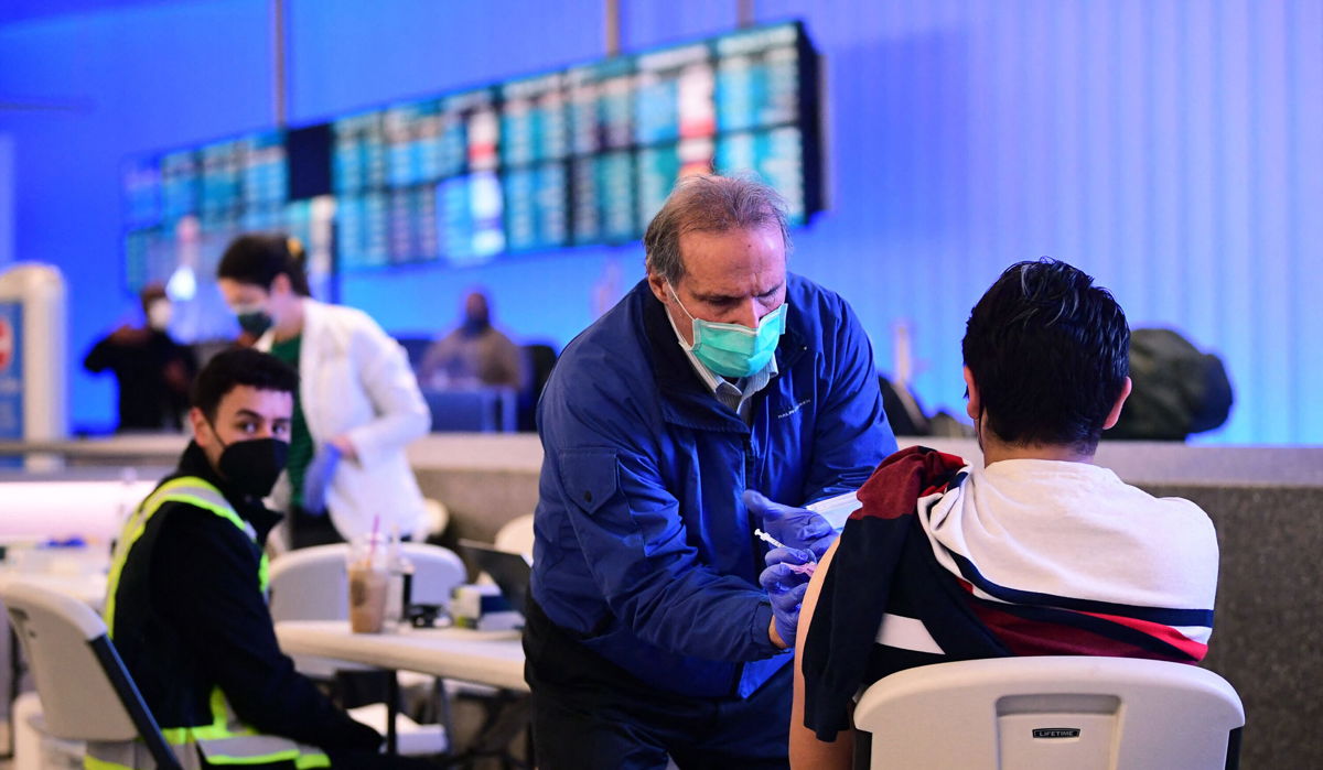 <i>Frederic J. Brown/AFP/Getty Images</i><br/>The Covid-19 vaccine is administered at a pop-up clinic at Los Angeles International Airport on December 22.