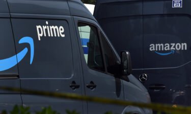 Amazon vans line up to pick up packages for delivery.