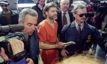 Ted Kaczynski is guided to his arraignment by federal marshals in Helena