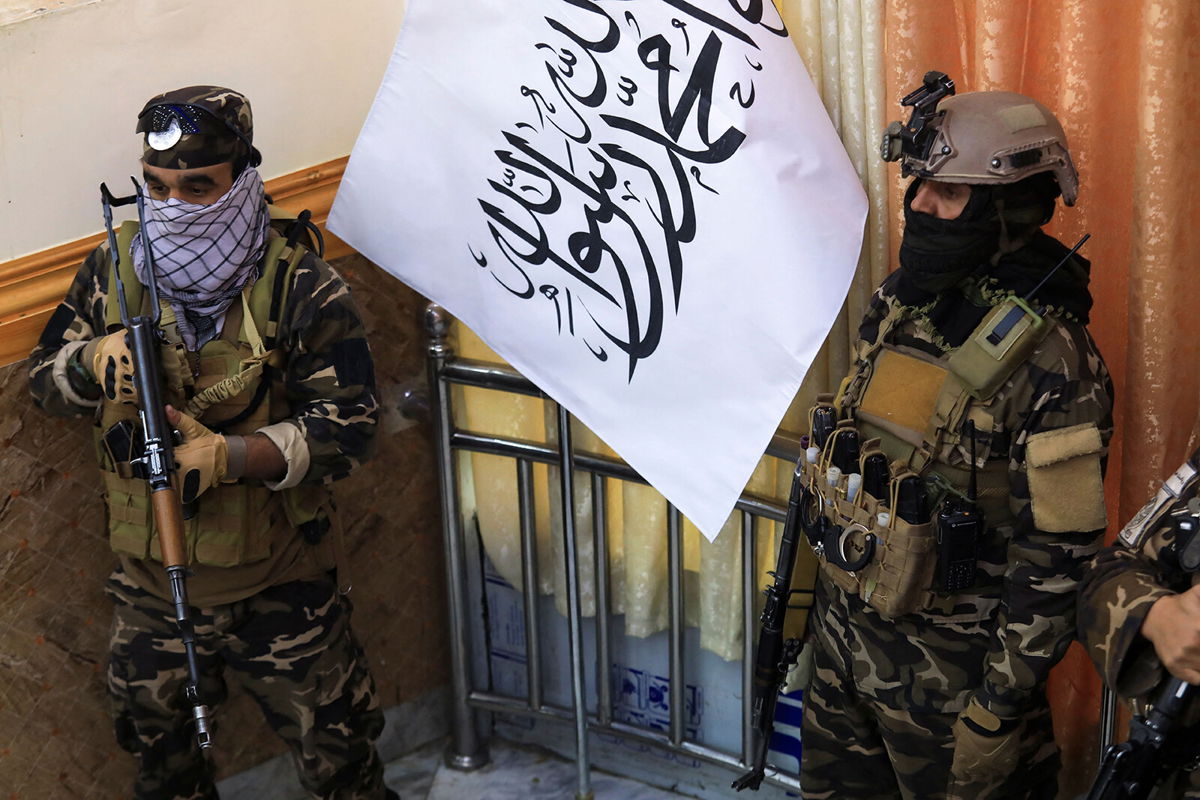 <i>Aref Karimi/AFP/Getty Images</i><br/>The United States and other countries are 'deeply concerned by reports of summary killings' in Afghanistan. Pictured are Taliban fighters standing guard next to a Taliban flag in Kabul on November 25.