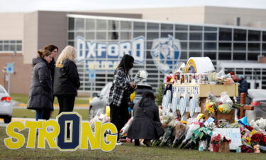 People gather at the memorial for the dead and wounded outside of Oxford High School in Oxford