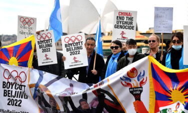 Protesters hold up placards and banners as they attend a demonstration in Sydney on June 23 to call on the Australian government to boycott the 2022 Beijing Winter Olympics over China's human rights record.