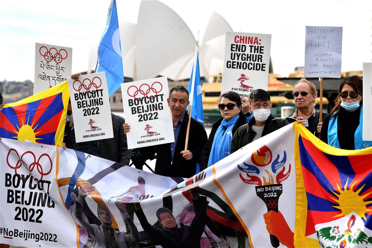 <i>Saeed Khan/AFP/Getty Images</i><br/>Protesters hold up placards and banners as they attend a demonstration in Sydney on June 23 to call on the Australian government to boycott the 2022 Beijing Winter Olympics over China's human rights record.