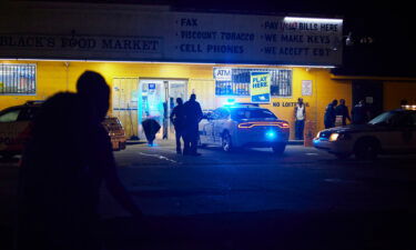 Police respond to a shooting outside a food market in Jackson. The city recently raised starting pay for new police officers to  $30