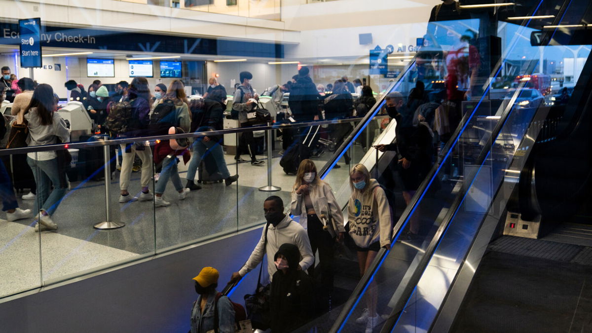 <i>Jae C. Hong/AP</i><br/>Travelers crowd the United Airlines check-in area at the Los Angeles International Airport on Wednesday