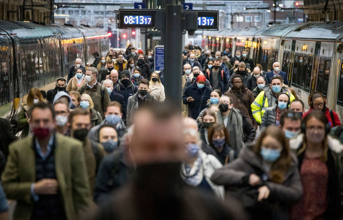 <i>Ben Cawthra/Sipa USA/AP</i><br/>Commuters disembark a train at Kings Cross station at rush hour in London