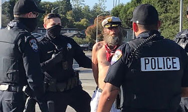 This photo provided by the Santa Cruz Police Department shows Ole Hougen being taken into custody by police officers in Santa Cruz