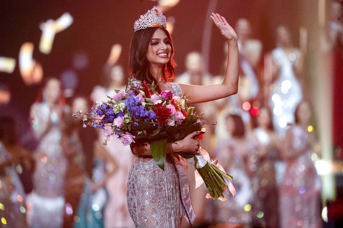 <i>Ariel Schalit/AP</i><br/>India's Harnaaz Sandhu waves after being crowned Miss Universe 2021 during the 70th Miss Universe pageant
