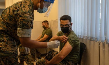 Marine Corps discharges 103 service members for refusing the Covid-19 vaccine. A Marine here prepares to receive the coronavirus vaccine at Camp Hansen on April 28