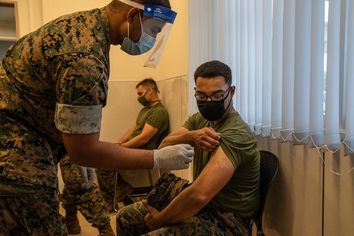 <i>Carl Court/Getty Images</i><br/>Marine Corps discharges 103 service members for refusing the Covid-19 vaccine. A Marine here prepares to receive the coronavirus vaccine at Camp Hansen on April 28