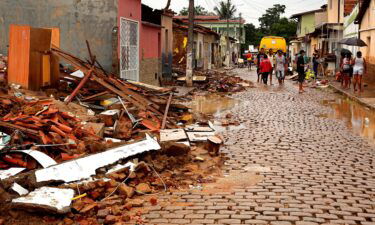People salvage their belongings from homes destroyed by flooding in Itapetinga.