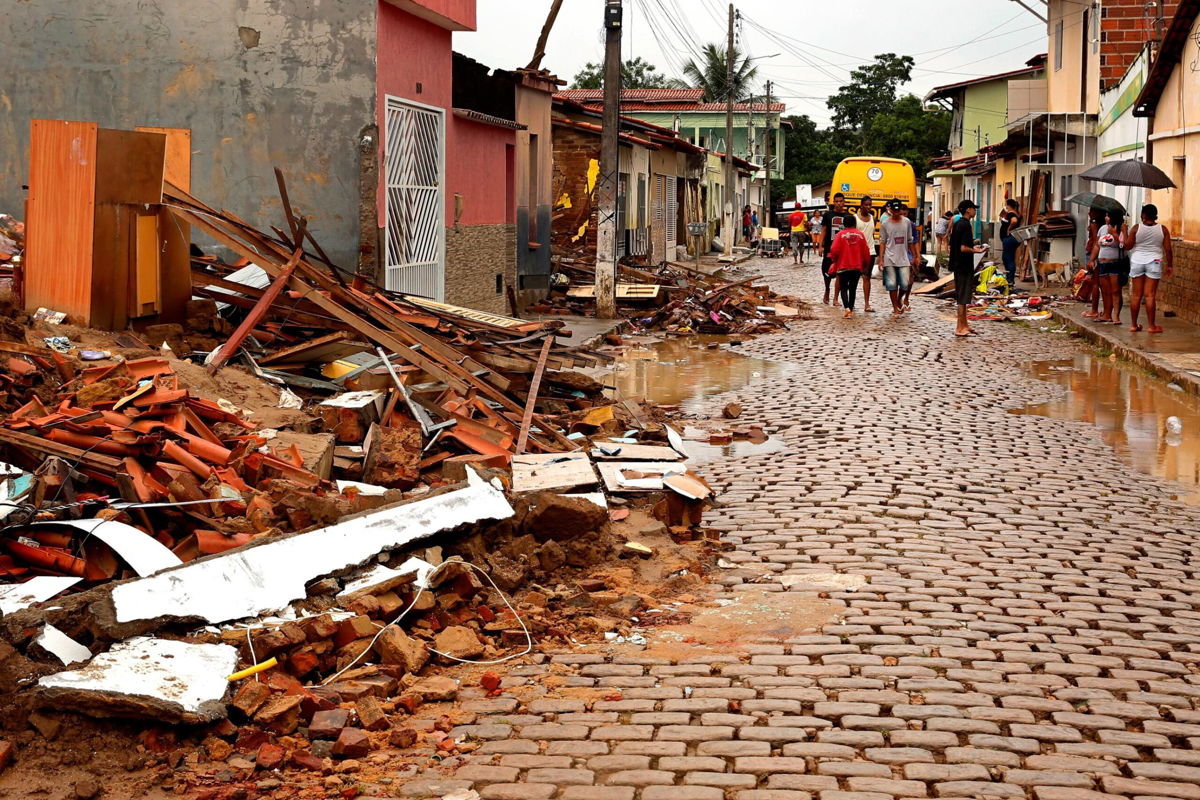 <i>Manuella Luana/AP</i><br/>People salvage their belongings from homes destroyed by flooding in Itapetinga.