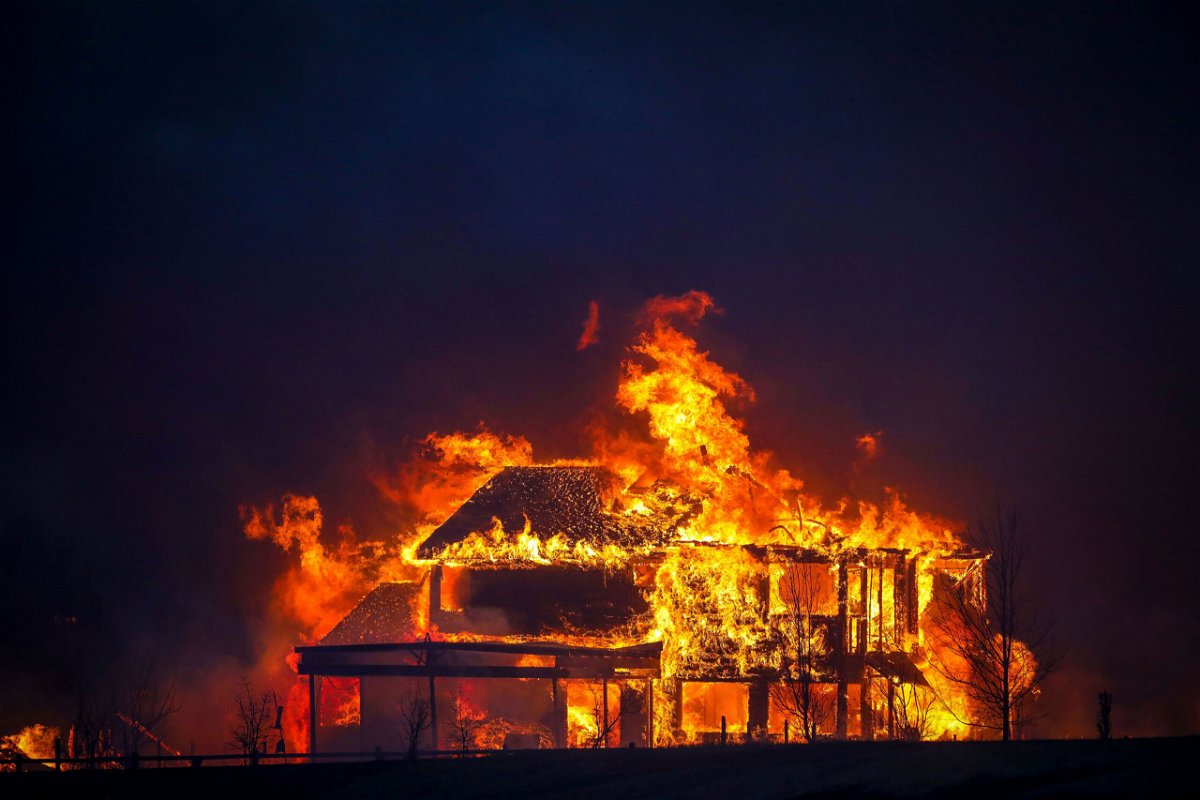 <i>Marc Piscotty/Getty Images</i><br/>A home burns Thursday after flames swept through the Centennial Heights neighborhood of Louisville