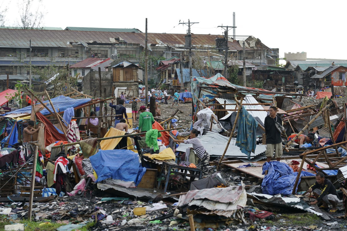 <i>Jay Labra/AP</i><br/>Residents salvage what's left of their damaged homes following Typhoon Rai in Cebu
