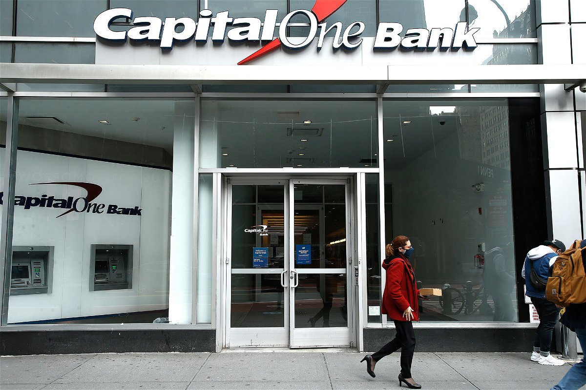 <i>John Lamparski/SOPA Images/LightRocket/Getty Images</i><br/>A woman wearing a face mask walks past the Capital One Bank branch in Midtown. Capital One announced it is getting rid of all fees for overdrafts and non-sufficient funds. It will also continue to allow customers to get free overdraft protection on their accounts.